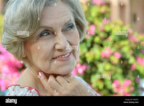 Older Woman With Flowers Stock Photo Alamy