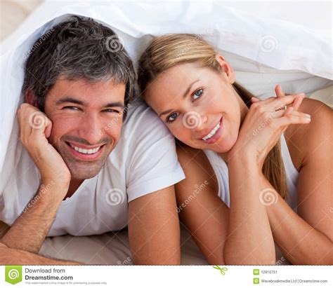 Enamoured Couple Having Fun Lying On Bed Stock Image Image 12810751