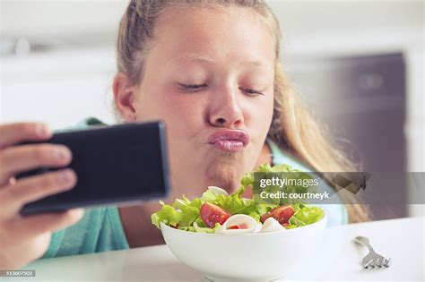 Teenage Girl Taking A Silly Selfie With Food High Res Stock Photo