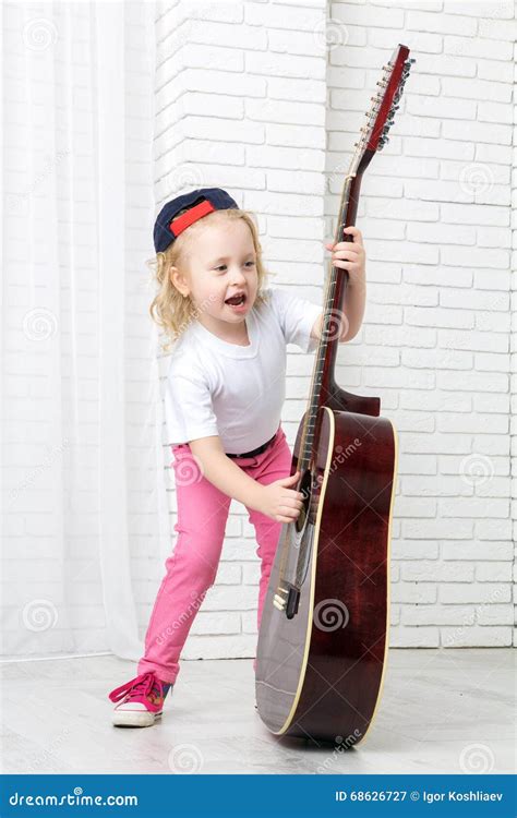 Little Girl Holding A Guitar And Singing Stock Image Image Of Hobby