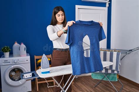 Young Brunette Woman Ironing Holding Burned Iron Shirt At Laundry Room