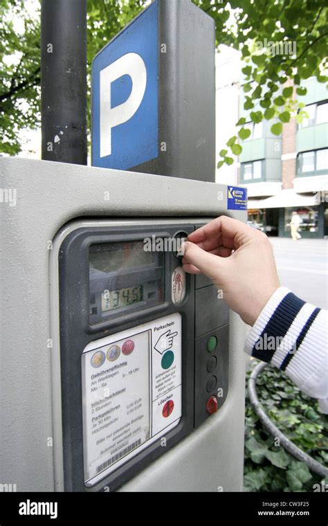 Man Putting Coins Into A Parking Meters Stock Photo Alamy