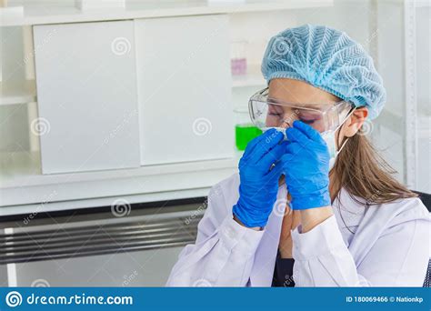 Female Scientist Wearing Safety Glasses And A Dark Blue Glove Wearing Hairnet,sitting In The ...