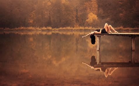 Woman Lying On Gray Wooden Dock Near Lake During Golden Hour Hd