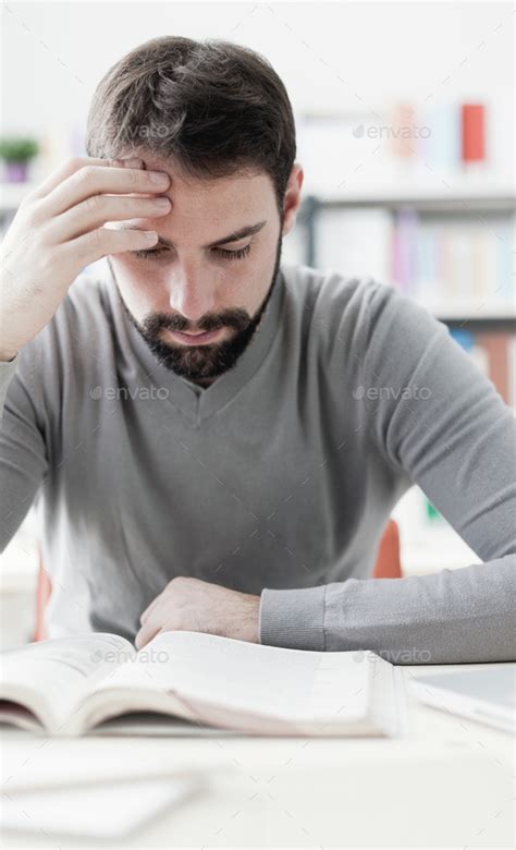 Man Studying At The Library Stock Photo By Stokkete Photodune