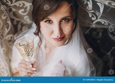 Beautiful Stylish Brunette Bride In Silk Robe And Veil Cheering With