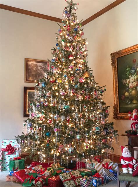 A Decorated Christmas Tree With Presents Under It