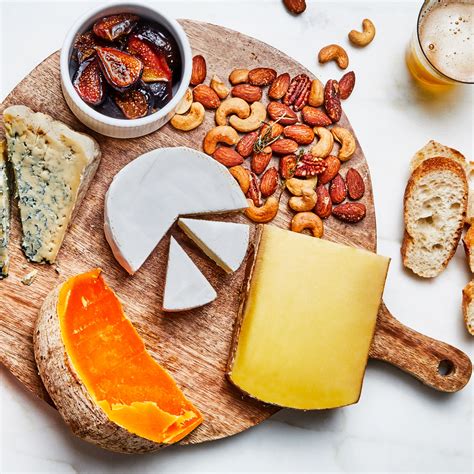 Cheese Board With Roasted Strawberries Garlic And Herb Nuts And Honey