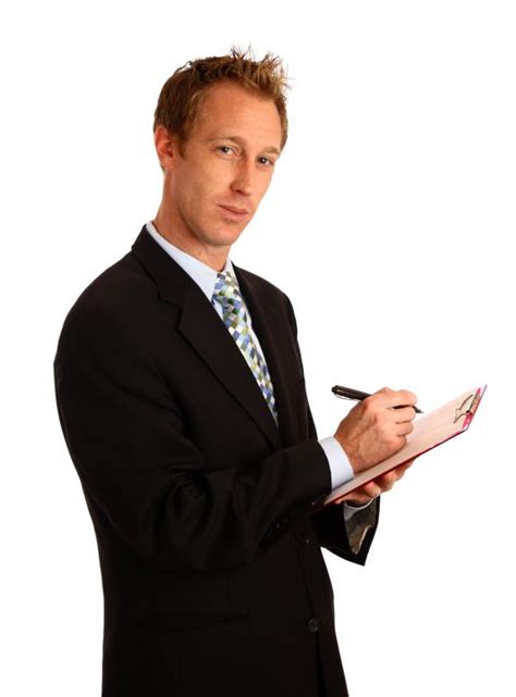 A Young Businessman Holding A Clipboard Free Stock Photo By Benjamin