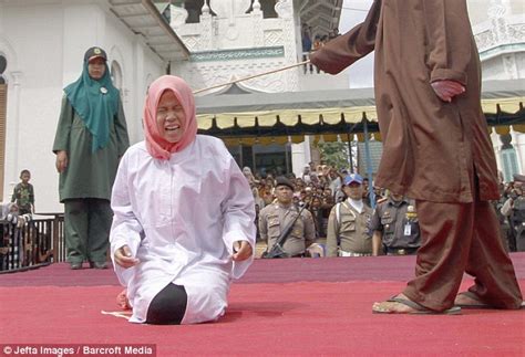 Screaming In Agony A Woman Collapses As She Is Caned Under Sharia Law In Indonesia Because She