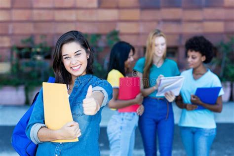 Successful Spanish Female Student With Group Of Students Stock Image