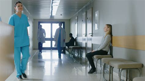 busy hospital hallway medical personnel doctors nurses surgeons walking stock footage ad