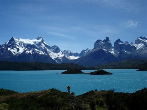 The Towering Cuernos Over A Beautiful Blue Lake In Patagonias Torres