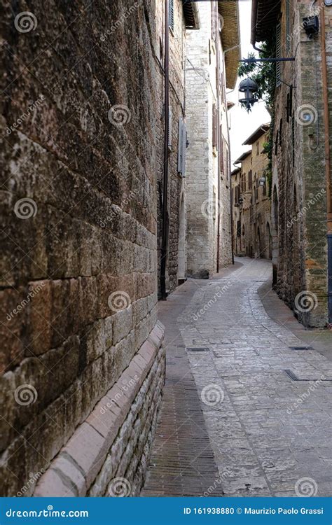 Alley Of The City Of Assisi With Stone Facades Of Historic Houses