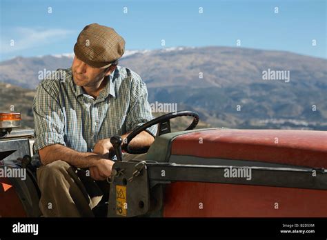 Farmer On Tractor Stock Photo Alamy