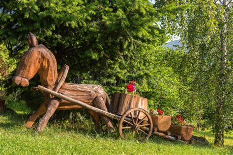 Wooden Horse And Cart Decorative Flowerbed In The Garden Stock Photo