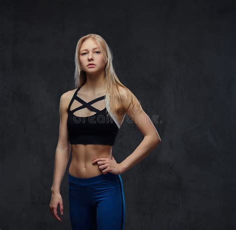 Slim Blonde Girl In A Sportswear Posing In A Studio Stock Image