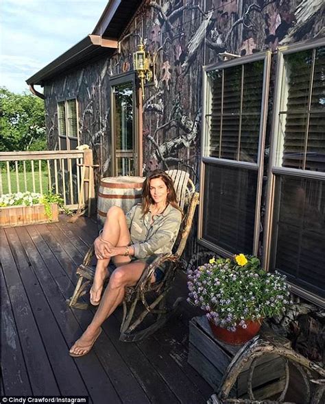 Cindy Crawford Flaunts Her Long Legs In Jeans Shorts And Camo Shirt On