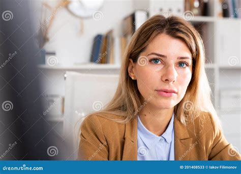 positive woman sitting and smiling in white room stock image image of happy professional
