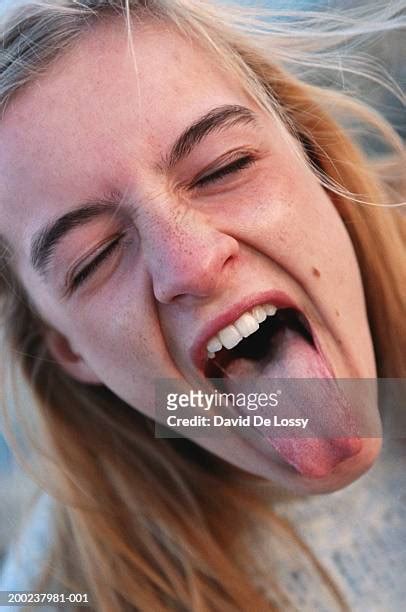 Blonde Girl Sticking Out Her Tongue Photos And Premium High Res