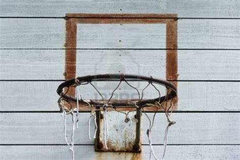 An Old Basketball Hoop Hanging From The Side Of A Building