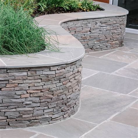 A Curvy Stacked Stone Wall Landscaping Retaining Walls Stone Walls