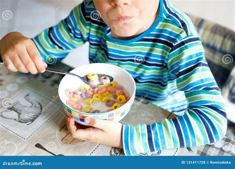 Adorable Little Blond School Kid Boy Eating Cereals With Milk And