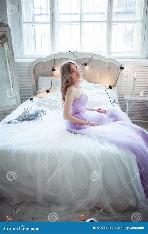 Very Beautiful Bride In A Delicate Purple Dress Sitting On The Bed Luxury Bedroom Decor With