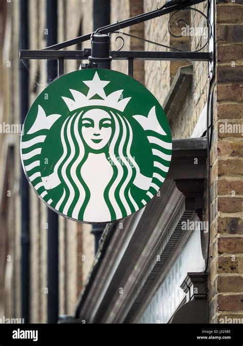 A Hanging Starbucks Coffee Sign In Londons East End Stock Photo Alamy