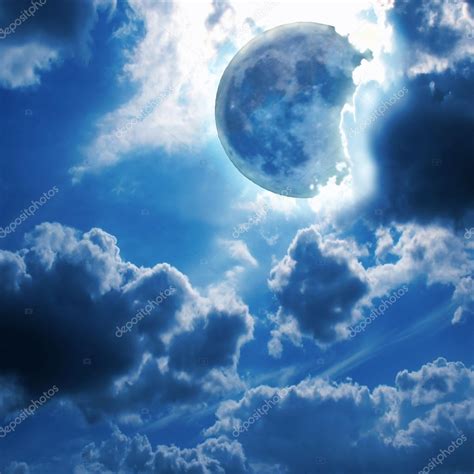 Full Moon Shines Through The Clouds In The Night Sky Stock Photo By