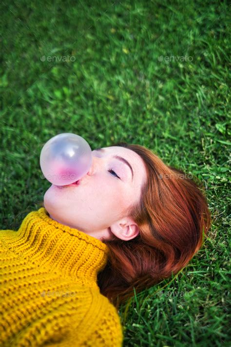 young woman chewing gum  making big balloon stock photo  diegocervo