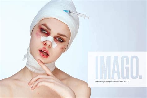 female patient bandaged face the syringe sticks out in the head isolated background female
