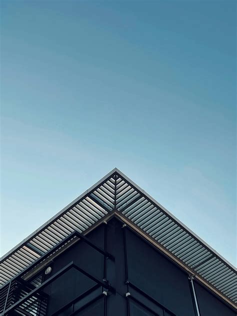 Part Of Modern Building Under Cloudless Blue Sky · Free Stock Photo