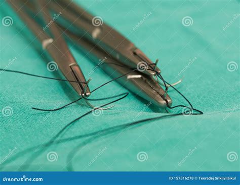 Three Needle Holders And Needles With Sutures Stock Photo Image Of