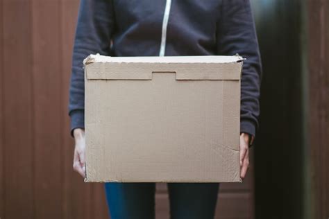 Free Photo Person Holding A Cardboard Box