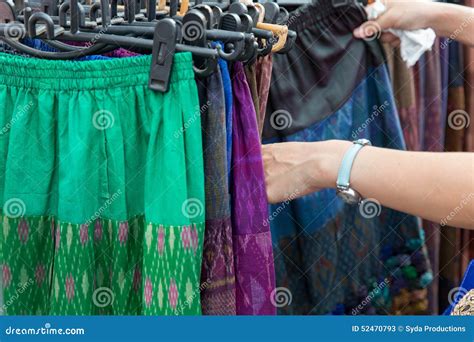 Close Up Of Hands Choosing Skirts At Street Market Stock Image Image