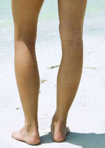 Woman Standing On Beach Close Up Of Legs Stock Photo Dissolve
