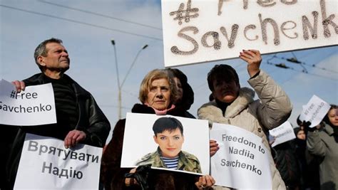 ukrainian activists hold posters with a portrait of nadiya savchenko and hashtag freesavchenko