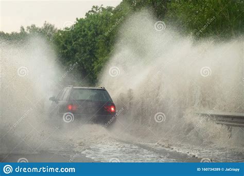 Car Runs Into Big Puddle At Heavy Rain Water Splashing