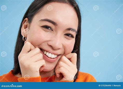 beauty and skincare close up portrait of happy smiling japanese woman touches her clear
