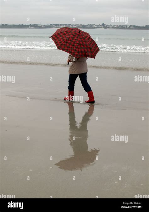 Mr Woman With An Umbrella Going For A Walk On Beach Autumn Bad Weather