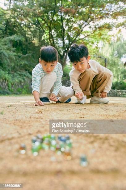 Children Playing Marbles Photos And Premium High Res Pictures Getty
