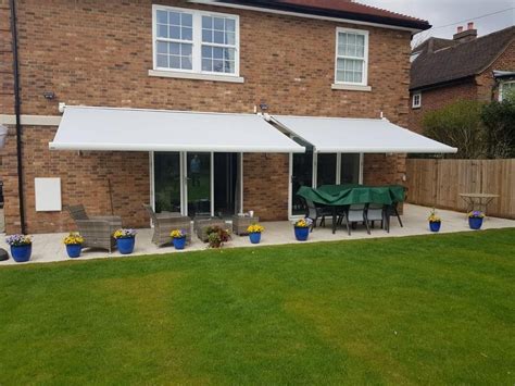 Two Awnings In White Fitted For Large Patio Space Outershade