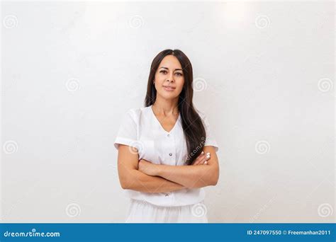 A Tanned Pretty Woman Smiles And Poses With Her Arms Crossed White