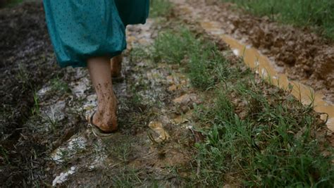 Woman Walking Barefoot Next To Muddy Road Stock Footage Video 14539723