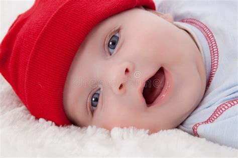 Adorable Baby Boy Lying Smiling With Red Hat On Stock Image Image Of