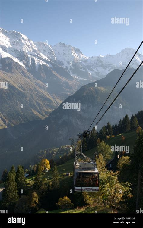 A Large Ski Lift Cable Car Climbs Over The Lauterbrunnen Valley Towards