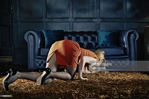 Woman Looking For Phone Under Sofa Photo Getty Images