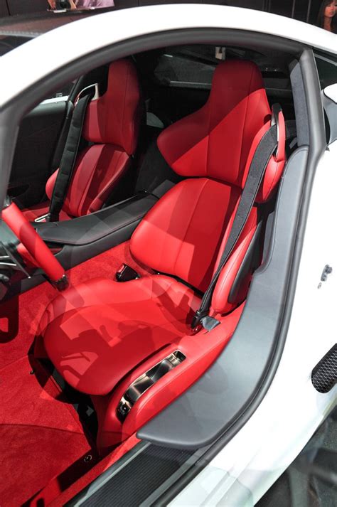 The Interior Of A Car With Red Leather Seats