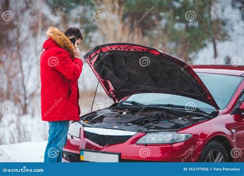 Man Standing Near Broken Car With Opened Hood Calling Help Stock Photo